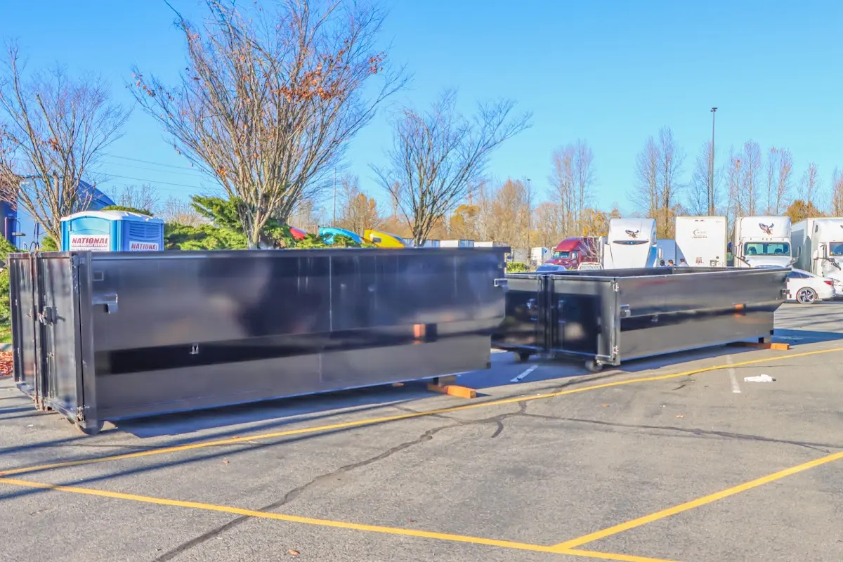 Professional dumpster rental service with roll-off container on residential driveway in West Vero Corridor